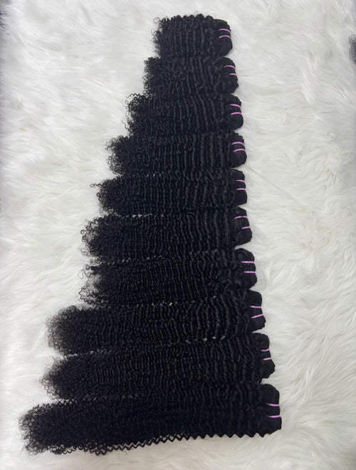 100% raw Vietnamese deep wave hair bundles in natural black showing tight defined curls arranged by length, Grade 12A

